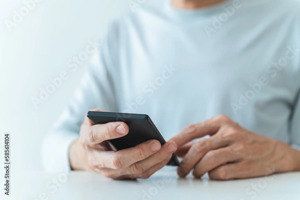 Fototapeta Man using social media application on smartphone for video, live streaming, meeting or conference online. Modern entertainment lifestyle and leisure via cyberspace technology like music and chat