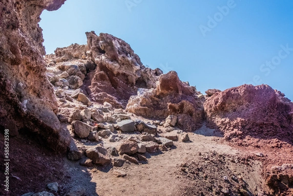 Fototapeta The red earth of the rocky coast of the red beach in santorini 