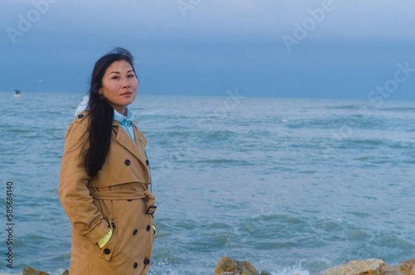 Obraz Dramatic portrait of a girl by the sea in winter