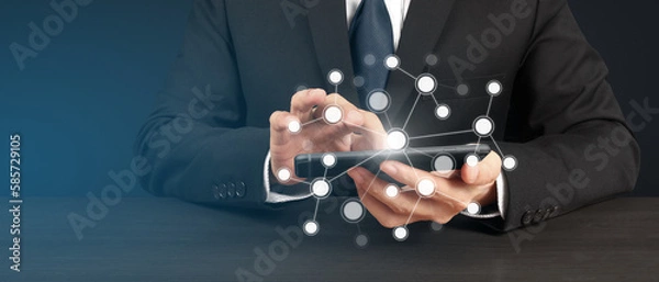 Fototapeta Man holding smartphone device and touching screen