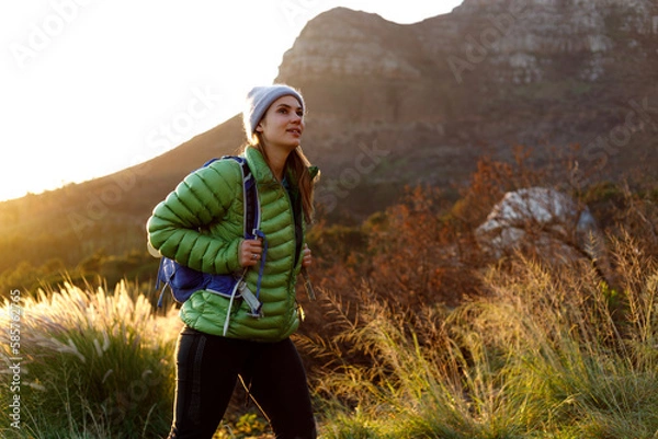 Fototapeta Portrait of smiling female caucasian hiker in winter clothes