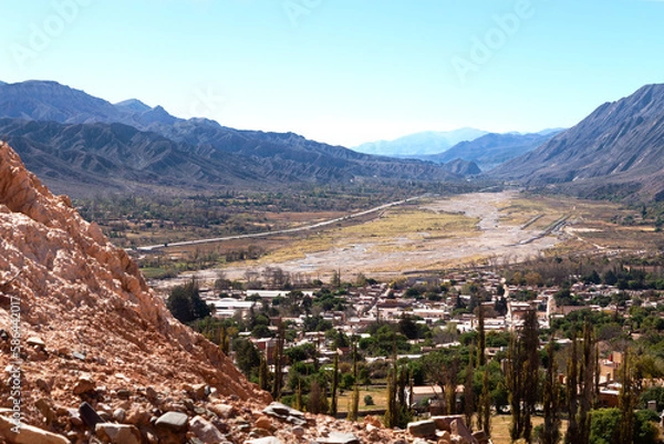 Fototapeta Tilcara town panoramic view seen from a height over the valley between Andes mountain ranges . 