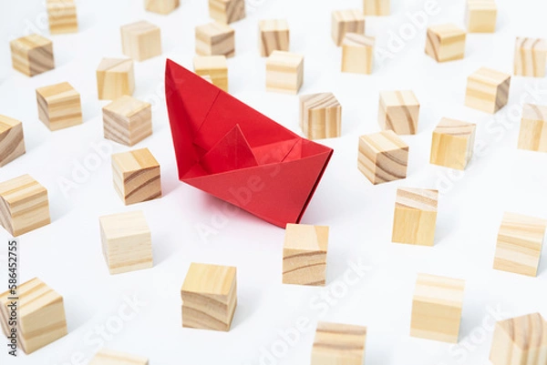 Obraz Conceptual photo of a paper ship and wooden blocks to overcome a business crisis