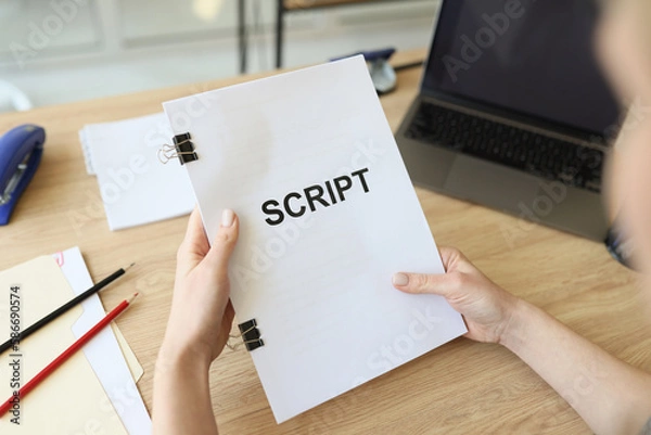 Fototapeta Hands of woman holding script papers for movie in hands