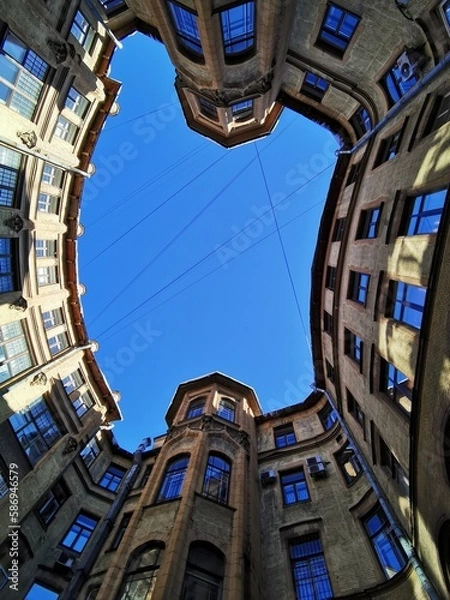 Obraz View from below on the blue sky, the courtyard-well of the original form, located in the center of St. Petersburg.	