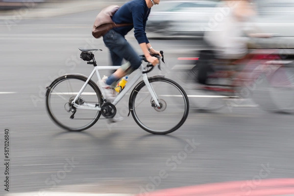 Obraz man on a racing bike in the city traffic