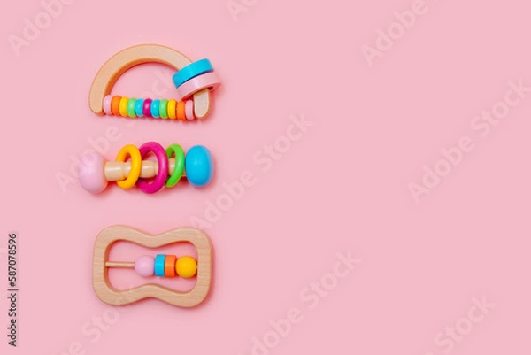 Obraz Cute set of wooden rattles. Eco-friendly toys for newborns in the colors of the rainbow. Flat lay, copy space.