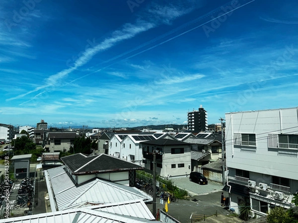Obraz 飛行機雲のある街並み
