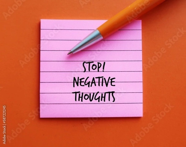Fototapeta Pink note on orange background with pen written STOP NEGATIVE THOUGHTS, means stop attracting negative life experiences, overcome and remove negative thinking and try not attract more painful events