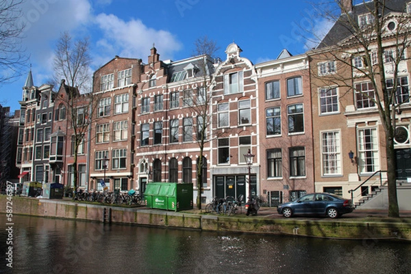 Obraz old brick houses and canal in amsterdam (the netherlands) 