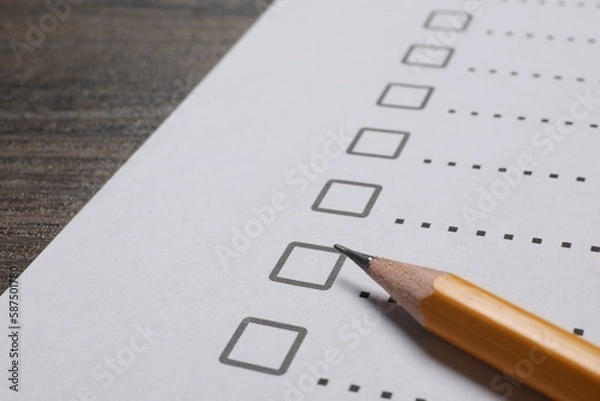 Fototapeta Paper sheet with checkboxes and pencil on wooden table, closeup. Checklist