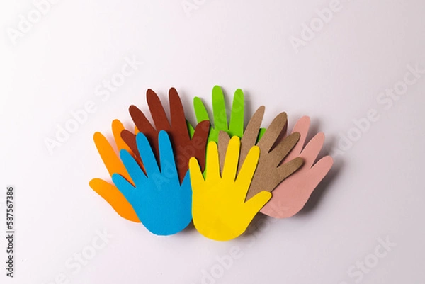 Obraz Close up of paper cut out of multi coloured hands with copy space on white background