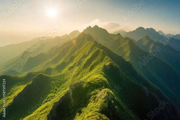 Obraz Beautiful sunrise over the green mountains in morning light with fluffy clouds on a bright blue sky. Nature freshness concept