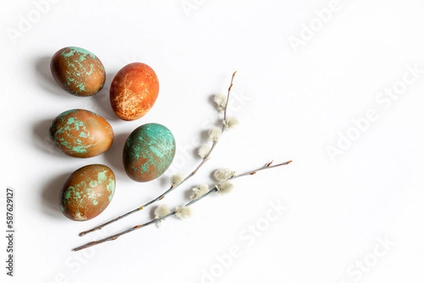Fototapeta Easter composition of colored chicken eggs and twigs of pussy willow on a white background