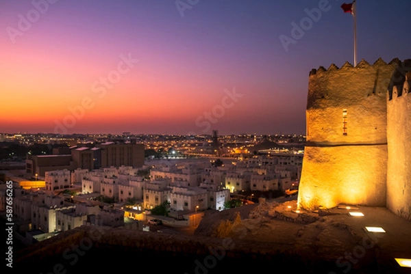 Obraz landscape showing top view of Bahrain, left side is Bahrain fort and rest is  houses with sunset