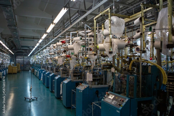 Obraz Textile industry with knitting machines in factory. Textile industry with a loom on the production of kapron tights.
