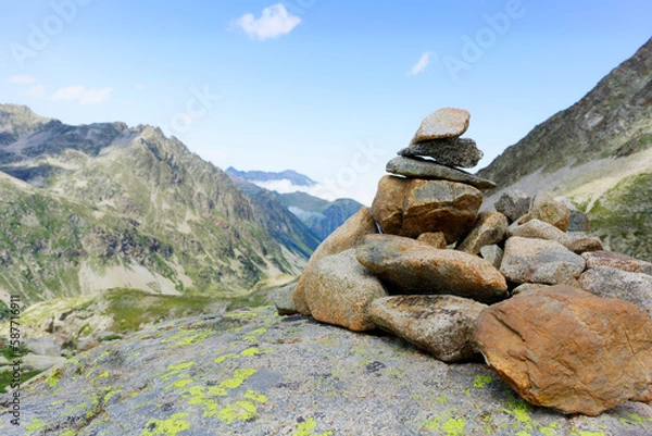 Fototapeta small cairn indicating the hiking trail in the Pyrenees. Small pile of pebbles indicating a milestone on a path in the mountains