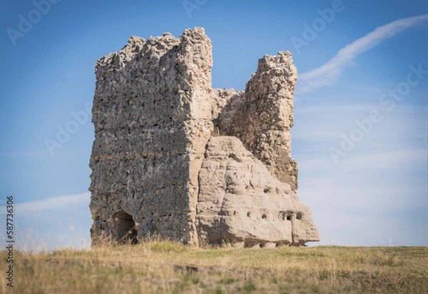 Obraz Ruins of the wall of the castle of Turegano in Segovia in the middle of the dry and yellow field in summer. Segovia. Spain