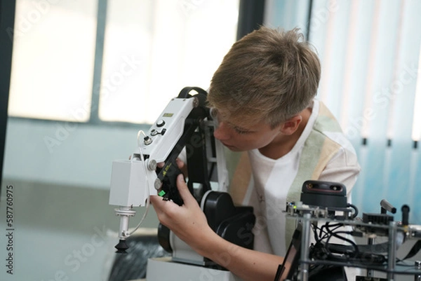 Fototapeta Children learning AI technology Robot with artificial intelligence system on its about the artificial intelligence during science lesson.