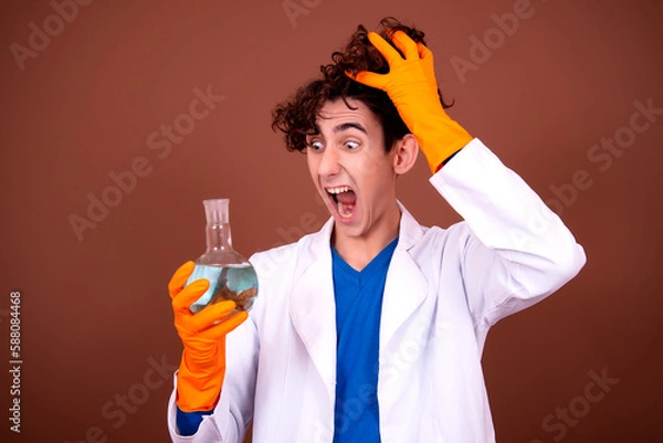 Obraz Crazy young scientist makes experiments in the office.