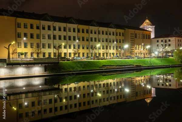 Fototapeta Large building near the river in the night