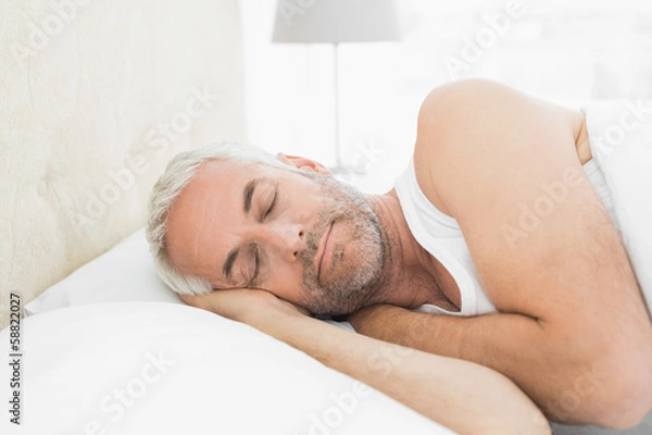 Fototapeta Close-up of a mature man sleeping in bed