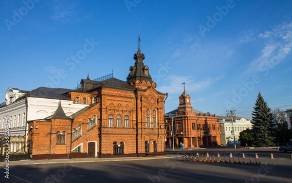 Obraz VLADIMIR, RUSSIA - AUGUST, 17, 2022: the historic brick facade of the Friendship House and the City Duma building in the old town on a sunny summer day and copy space