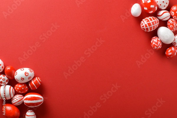 Fototapeta Easter backgrounds, scattered Easter red and white eggs on a bright red background.