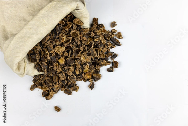 Fototapeta Raw Carob Kibble Nibbles, Top View Isolated on a White Background, for Snacks and Healthy Eating