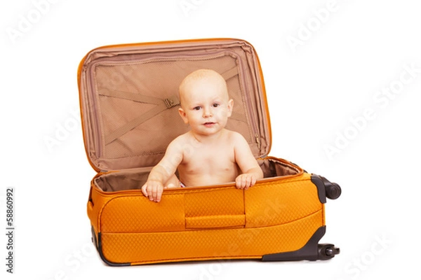 Fototapeta The small child in suitcase for long trips.