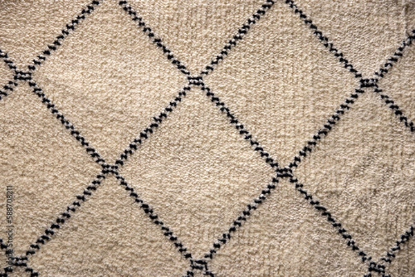 Obraz Beige fabric texture. Close-up of a light brown carpet textile background with a pattern of squares. Macro photograph. Beautiful bright backdrop with space.