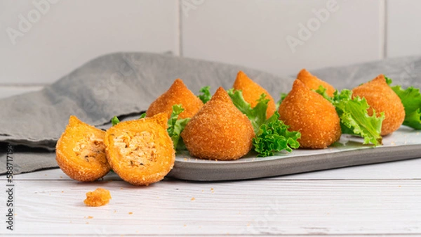 Fototapeta Traditional fried coxinha de frango - croquette of chicken on the white table, Brazilian snack.