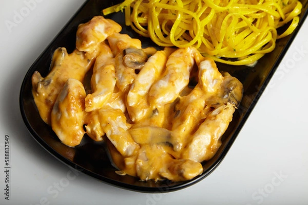 Fototapeta Grilled Chicken With Cheddar Sauce and Linguine Pasta with Green Salad White Background Close Up