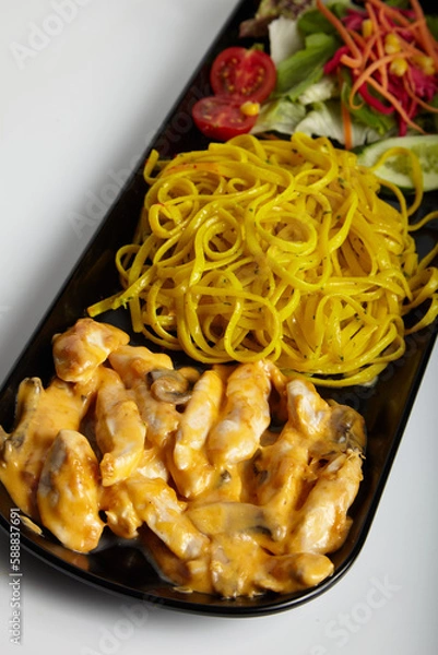 Fototapeta Grilled Chicken With Cheddar Sauce and Linguine Pasta with Green Salad White Background