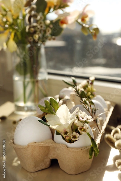 Fototapeta Festive composition with eggs and floral decor on windowsill indoors. Happy Easter