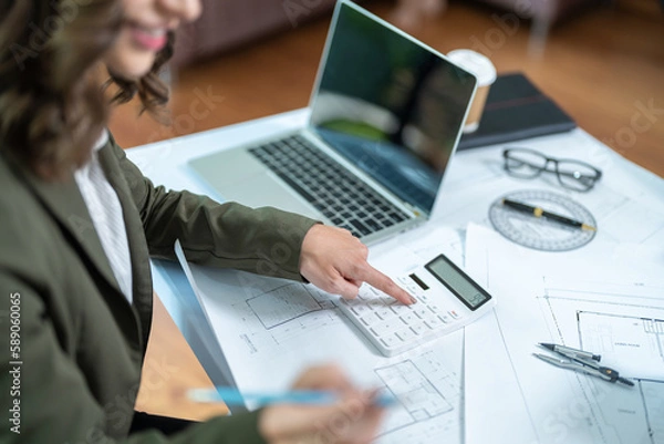 Fototapeta Portrait of young female architect working on project