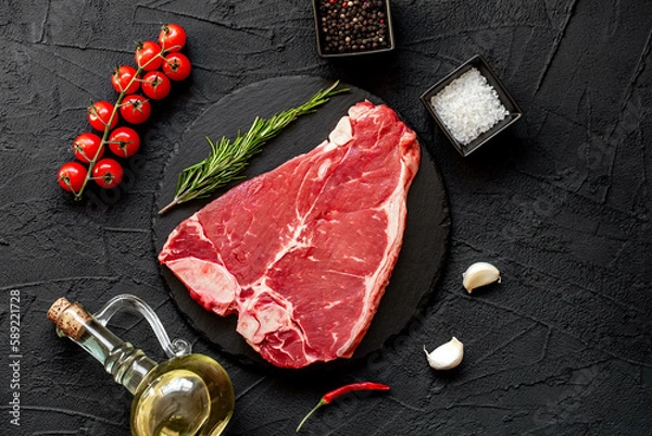Fototapeta raw T-bone steak on stone background