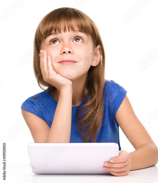 Fototapeta Young girl is using tablet
