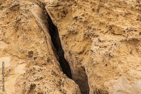 Obraz A large deep crack in the ground. Detached earth plates after an earthquake, large crack