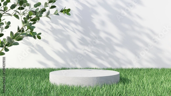 Fototapeta Round concrete podium in green grass with boxwood branches on white wall background with beautiful shadows from leaves. Mockup for product presentation
