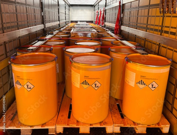 Fototapeta Loading, transportation and unloading of barrels with hazard class 9 in a semi-trailer. Transportation of dangerous goods by ADR cargo transport