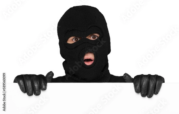 Fototapeta Thief hiding behind an empty white sign with space for text isolated on white background