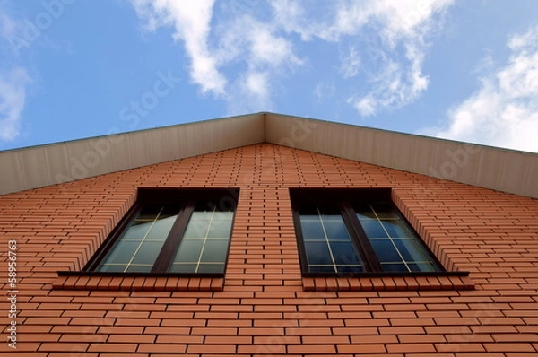 Obraz A house wall with two large windows