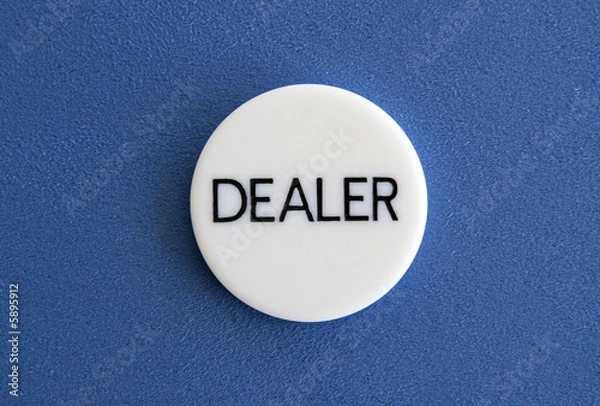 Fototapeta The white dealer button of a poker game