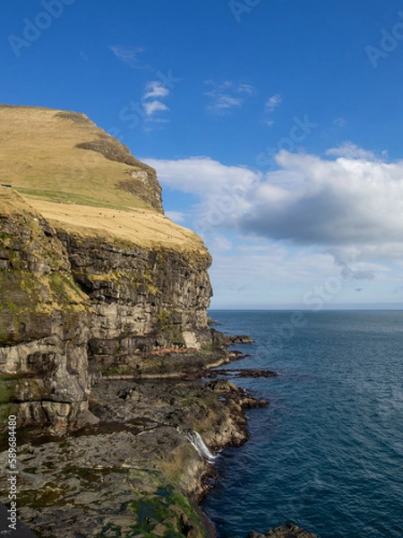 Fototapeta Kalsoy coastline cut in the mountain cliffs near Mikladalur
