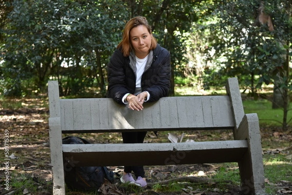 Fototapeta Model in a park behind a chair in the Botanical Garden of Bogota Colombia