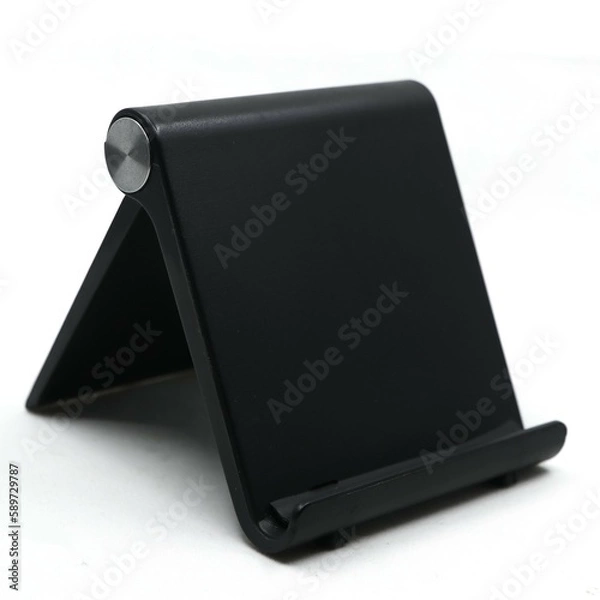 Fototapeta a black mobile phone holder stand which is foldable and adjustable for multiple angles isolated in a white background