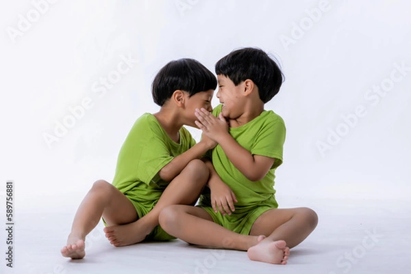 Fototapeta Portrait of cute Asian twins boys. two little boys twins isolated on white background. twins boys fun together on white background