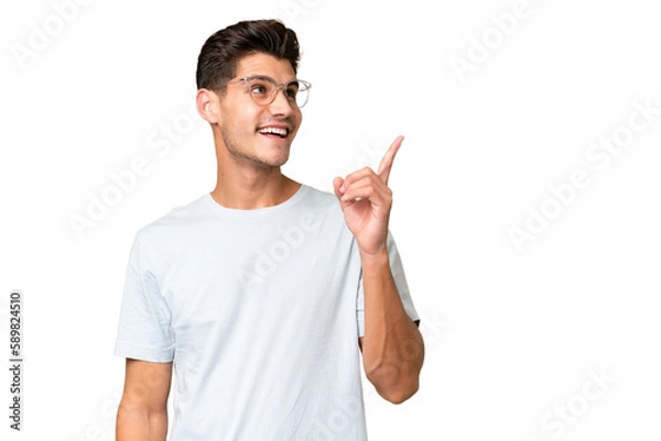 Fototapeta Young caucasian handsome man over isolated background intending to realizes the solution while lifting a finger up