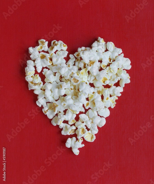 Fototapeta Heart shaped pop corns over textured red background